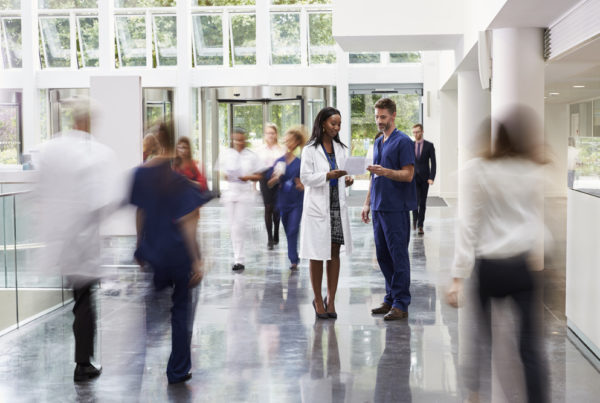 doctor in a busy hospital lobby