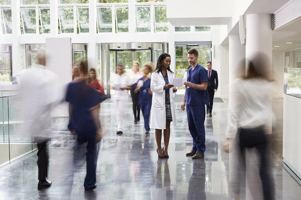 doctor in a busy hospital lobby
